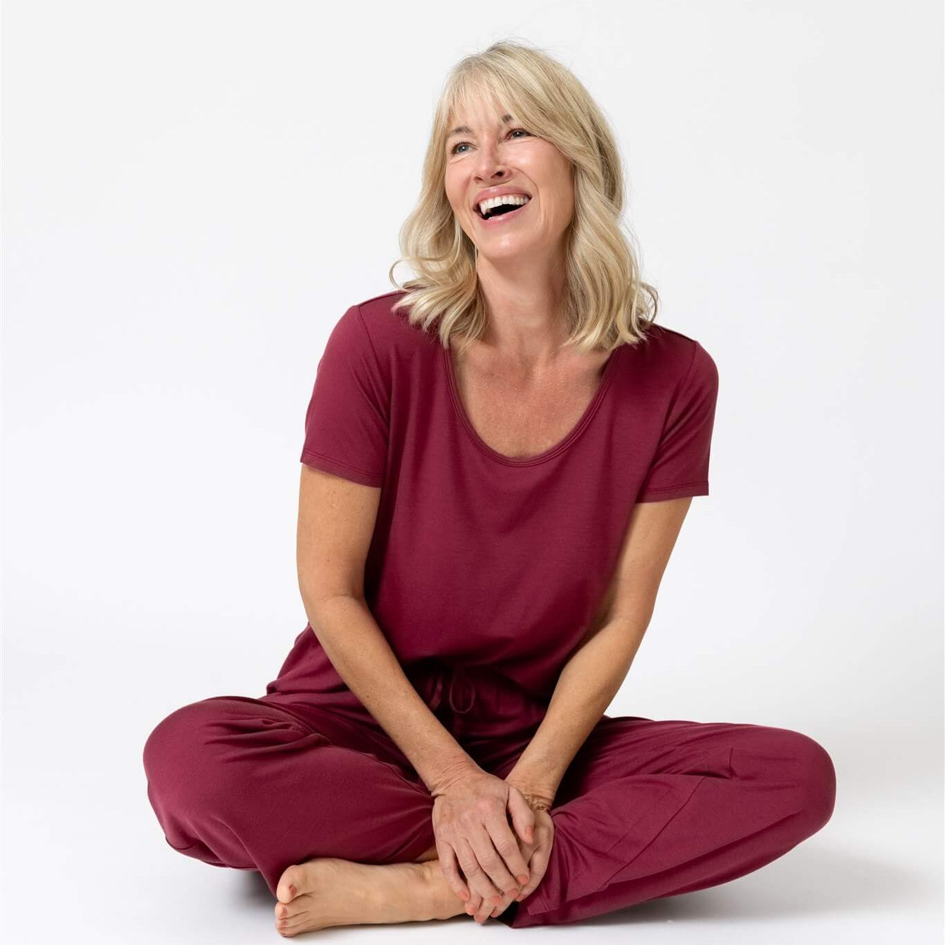 Woman in holiday exclusive merlot sweat wicking piper & mint pajamas